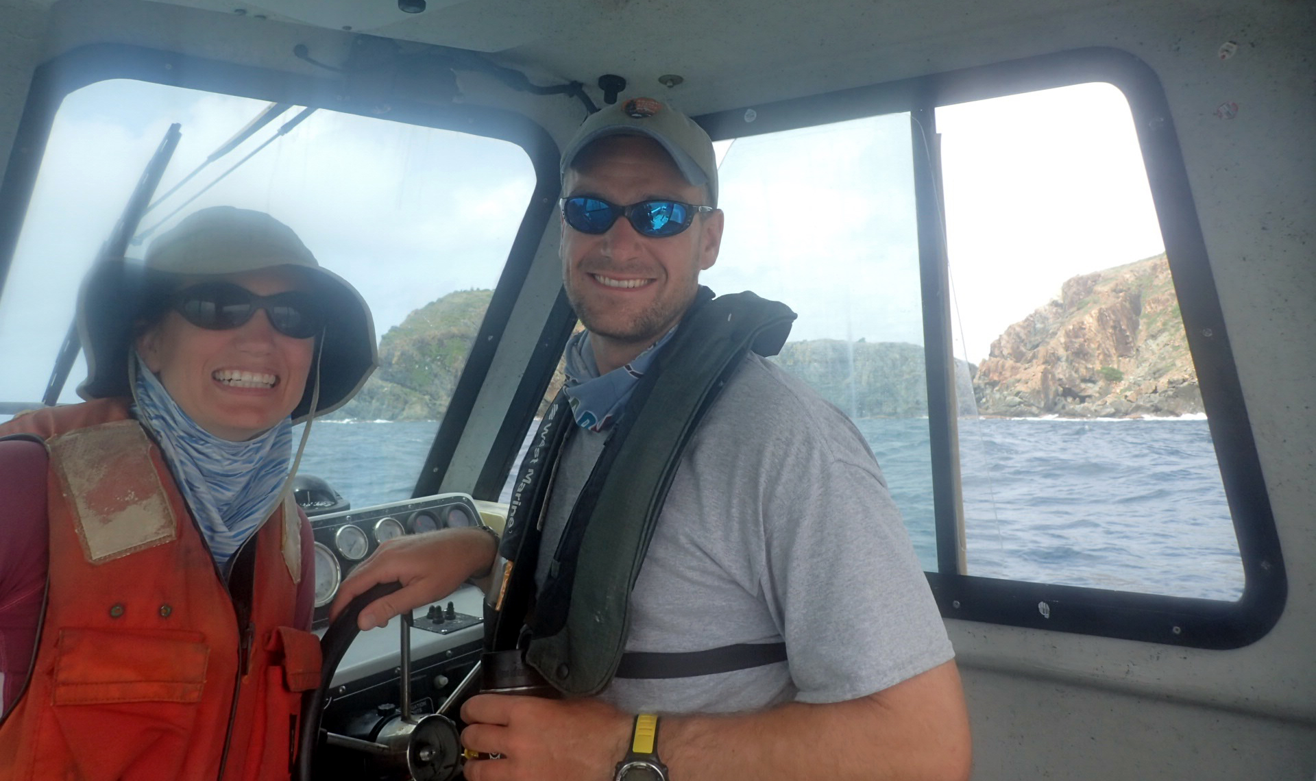 Two divers pose for a picture inside a boat