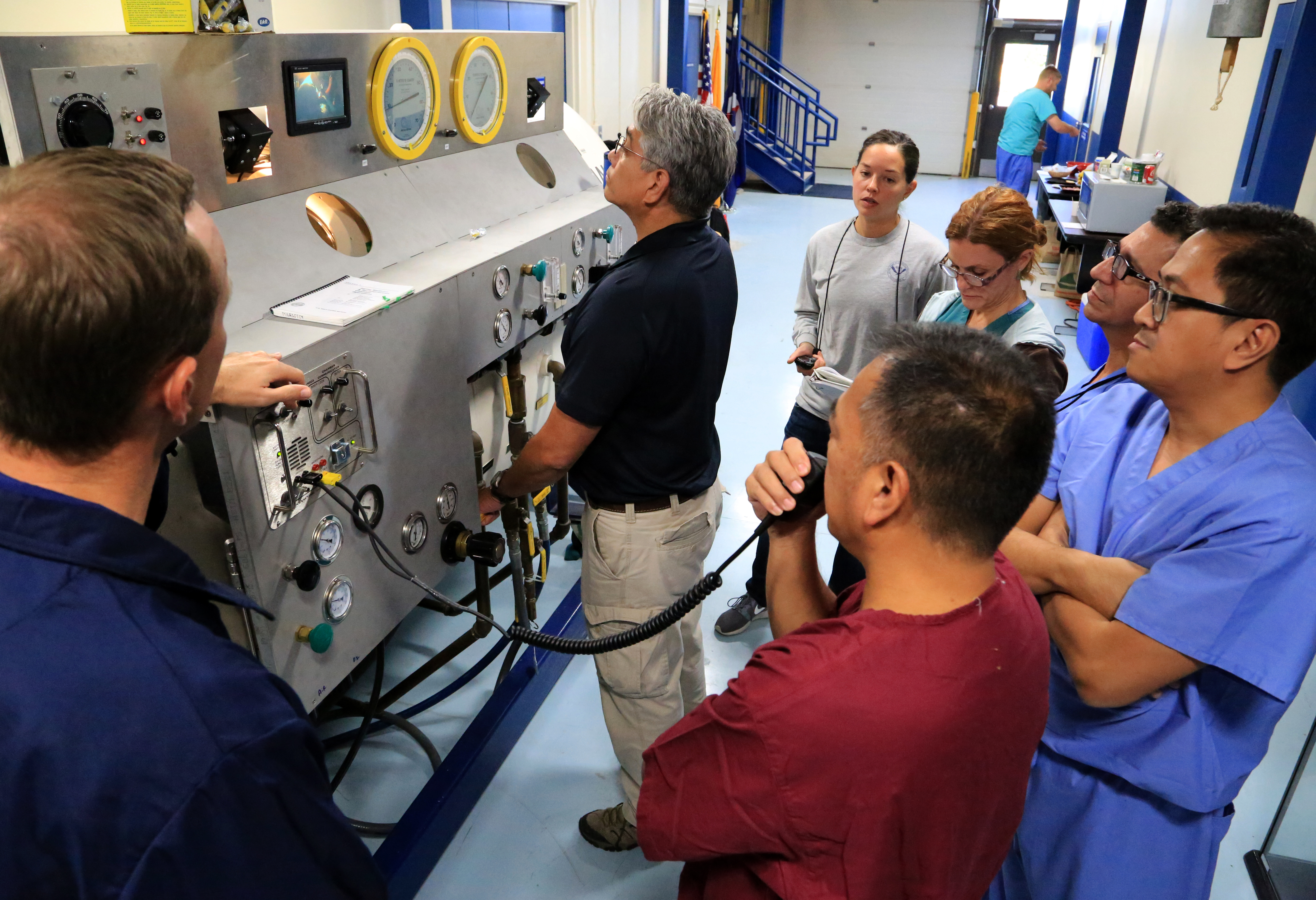 Students operating a 60" hyperbaric chamber at the NOAA Diving Center.