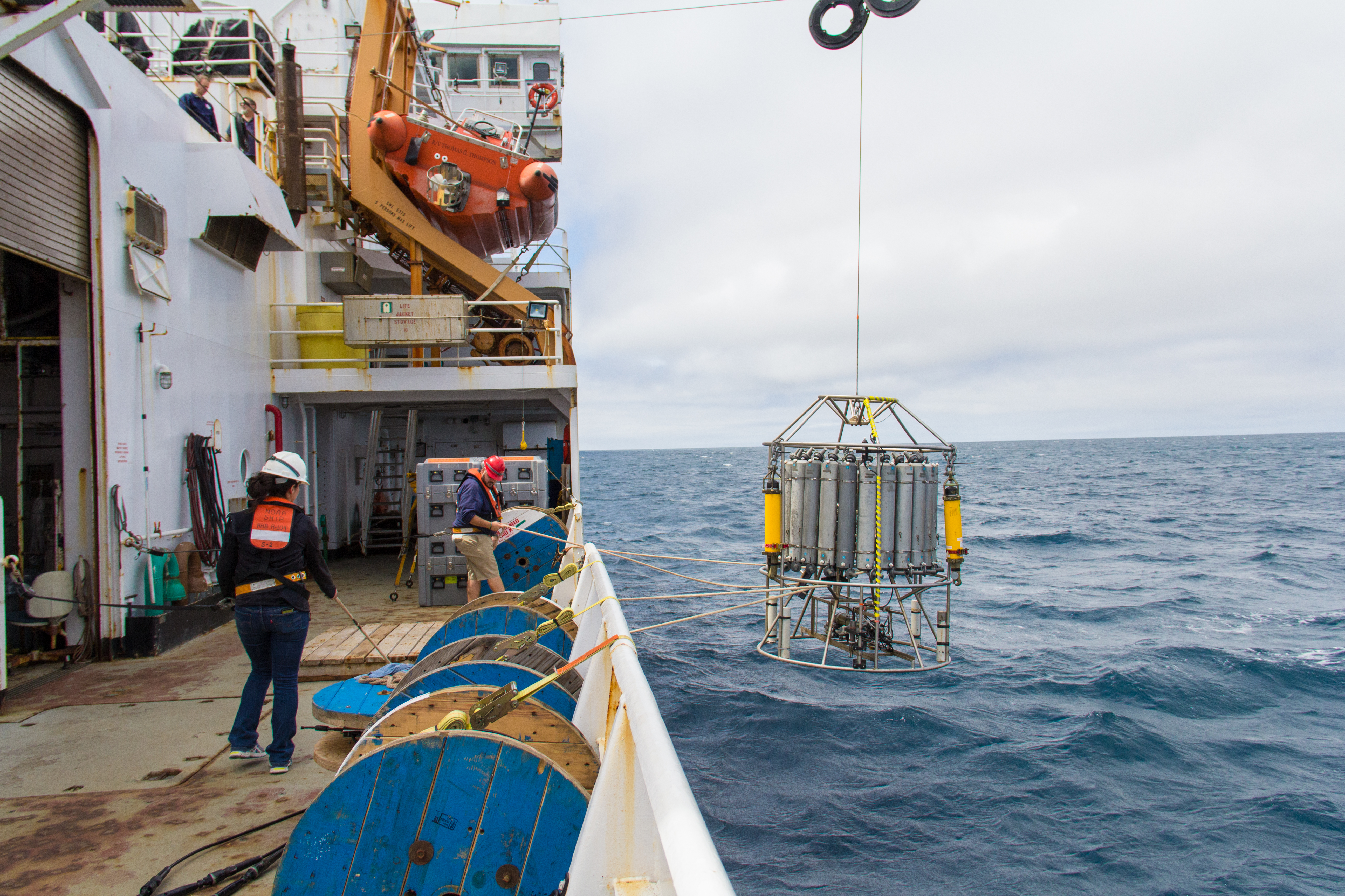 NOAA Ship Ronald H. Brown crew members deploy an instrument that measures water conductivity, salinity and temperature in the Gu