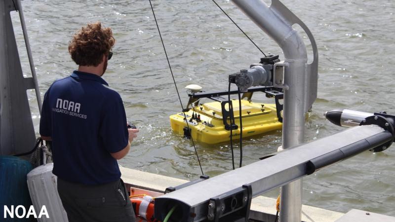 A yellow autonomous surface vehicle in the water