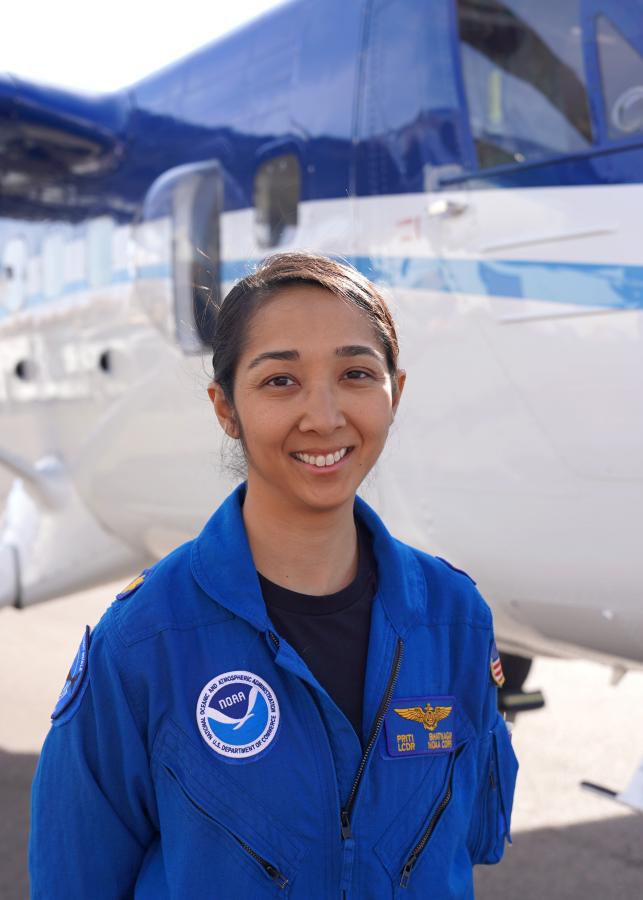 NOAA Corps Officer poses in front of NOAA Twin Otter