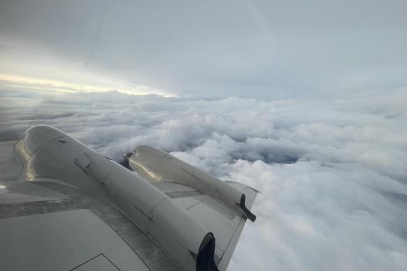 View showing right wing of NOAA aircraft and clouds from Tropical Storm Idalia