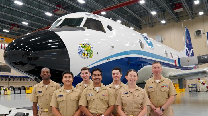 NOAA Commissioned Officer Corps pilots stand in front of NOAA WP-3D Orion "Kermit" during their tour of the NOAA Aircraft Operations Center in Lakeland, FL.(From L to R): Ensigns Ghislain Martial Ngangnang Ngangte, Wally Wilbowo, Christian Eden, Brian D'Souza, James Seibert, Sara Towers, Dylan Legus-Sleigh