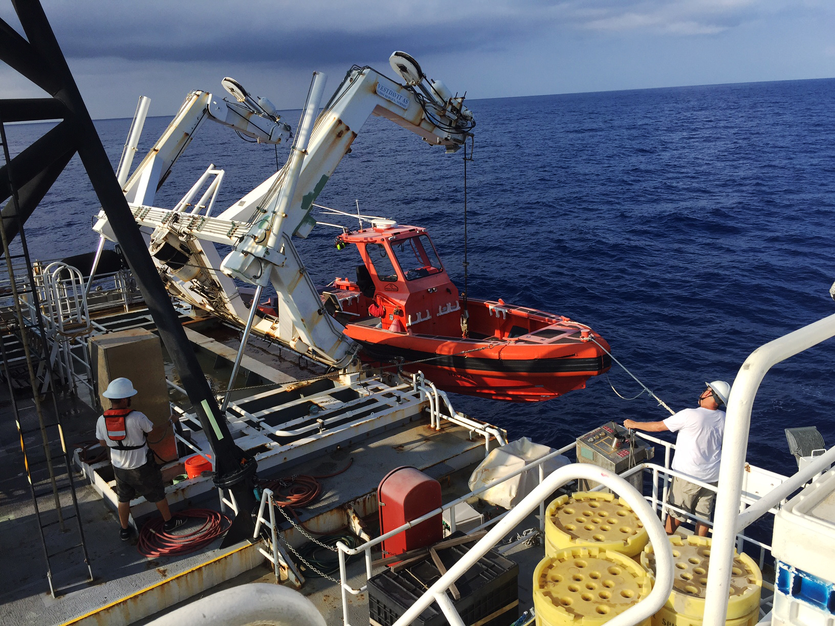 Crew members prepare to launch a boat from NOAA Ship Hi'ialakai