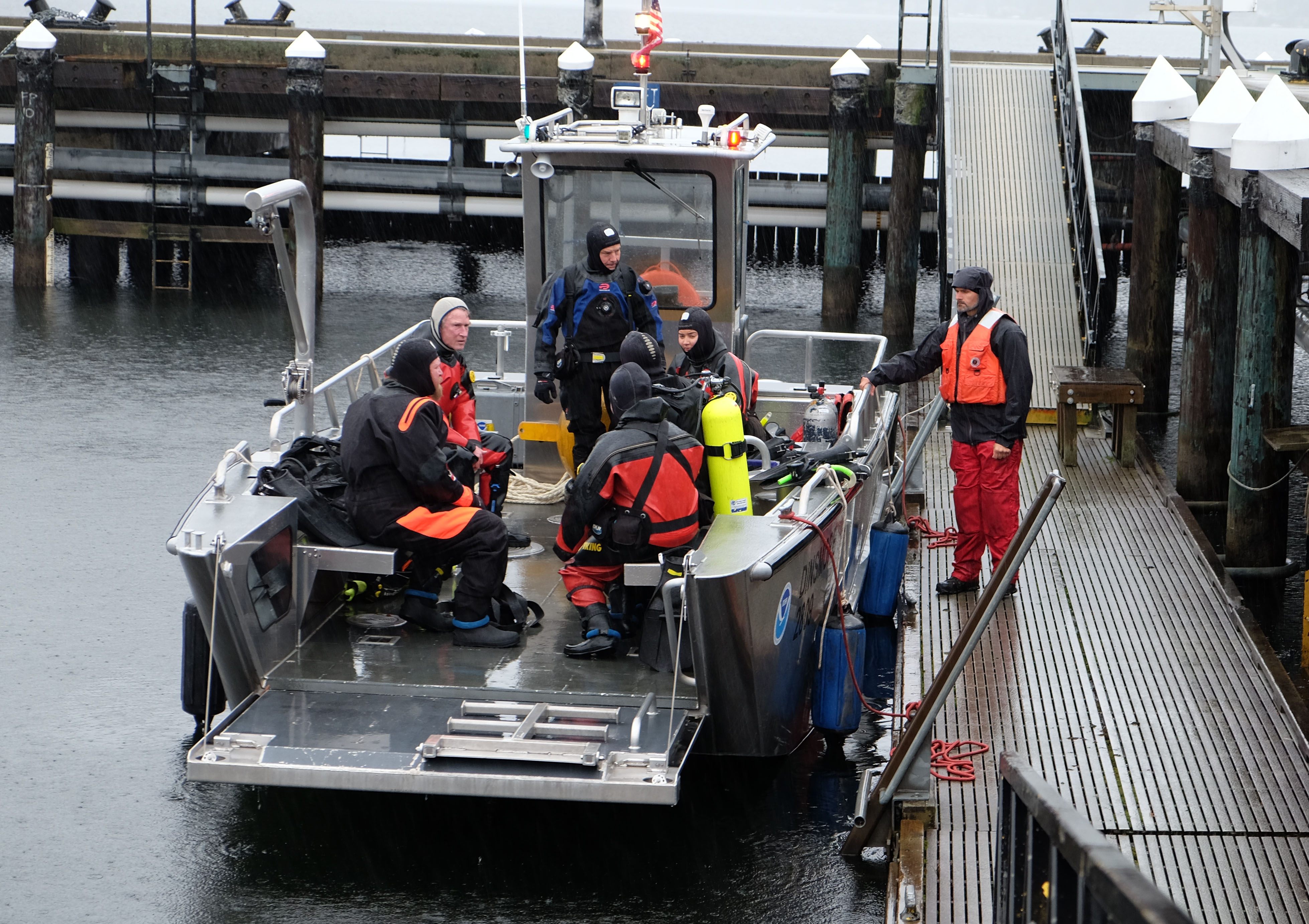 Divers on a boat getting ready for a dive