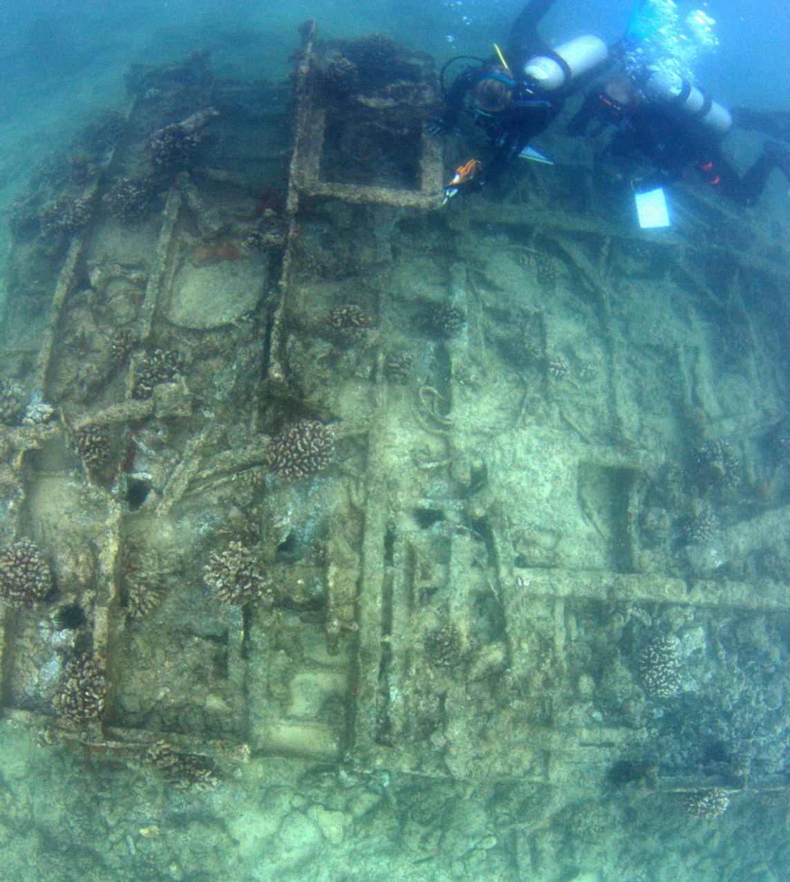 Two divers surveying a World War II-era wreck