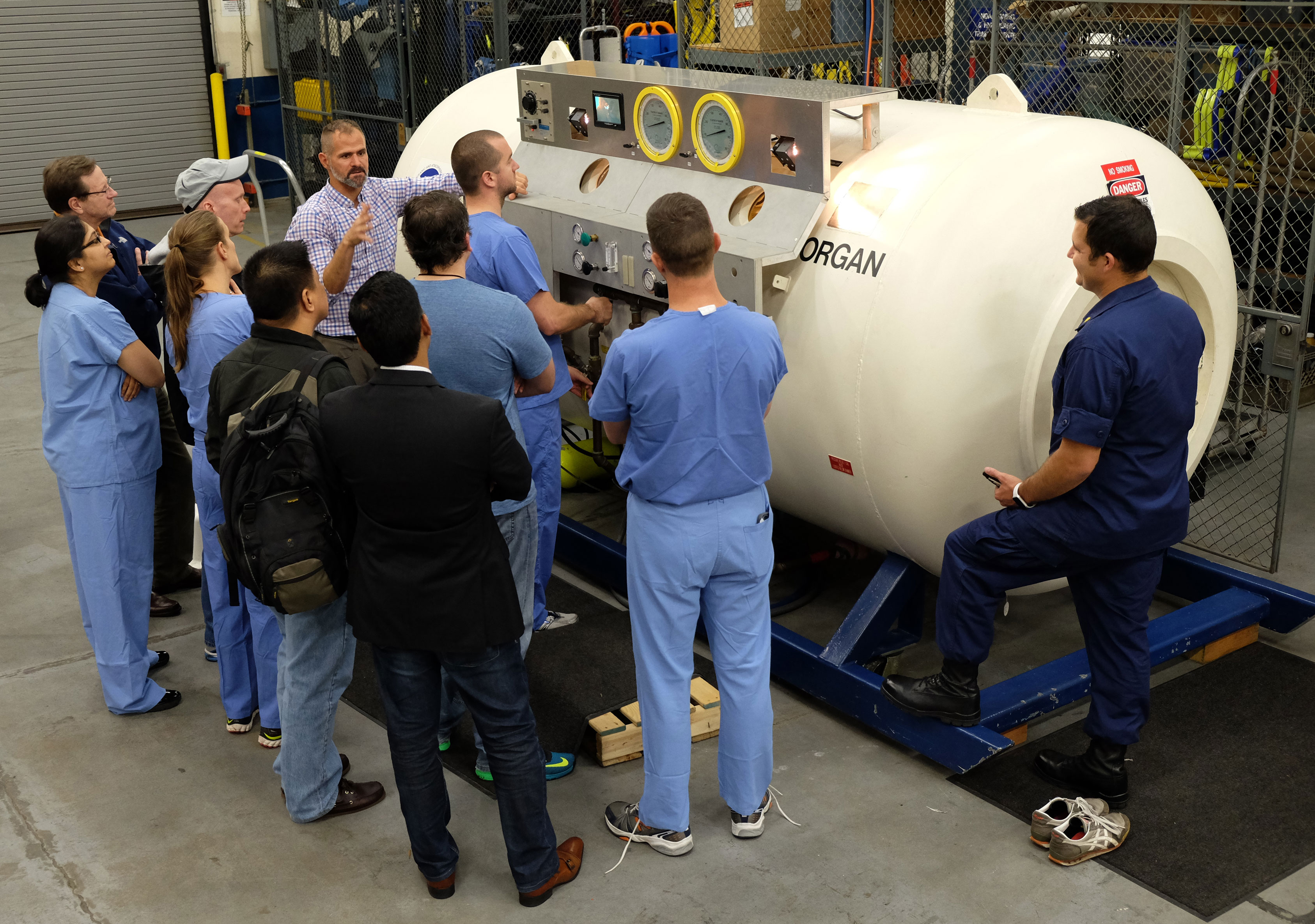 Students learning to operate a 60 inch hyperbaric chamber