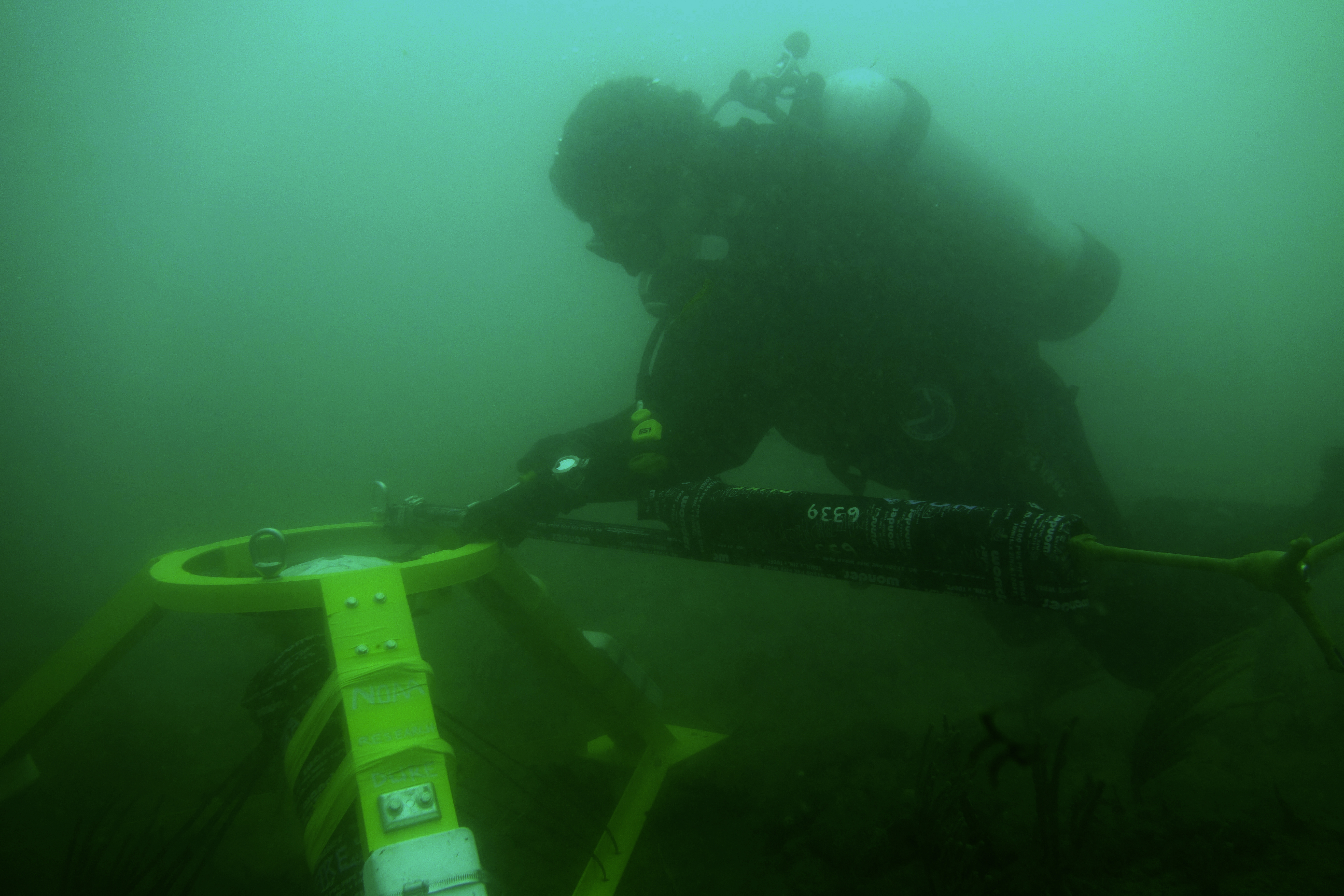 NOAA Diver assembling an Acoustic Doppler Current Profiler (ADCP) NOAA Diver assembling an Acoustic Doppler Current Profiler (ADCP) underwater
