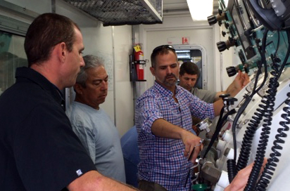 A NOAA Diving Center instructor demonstrates how to operate a hyperbaric chamber