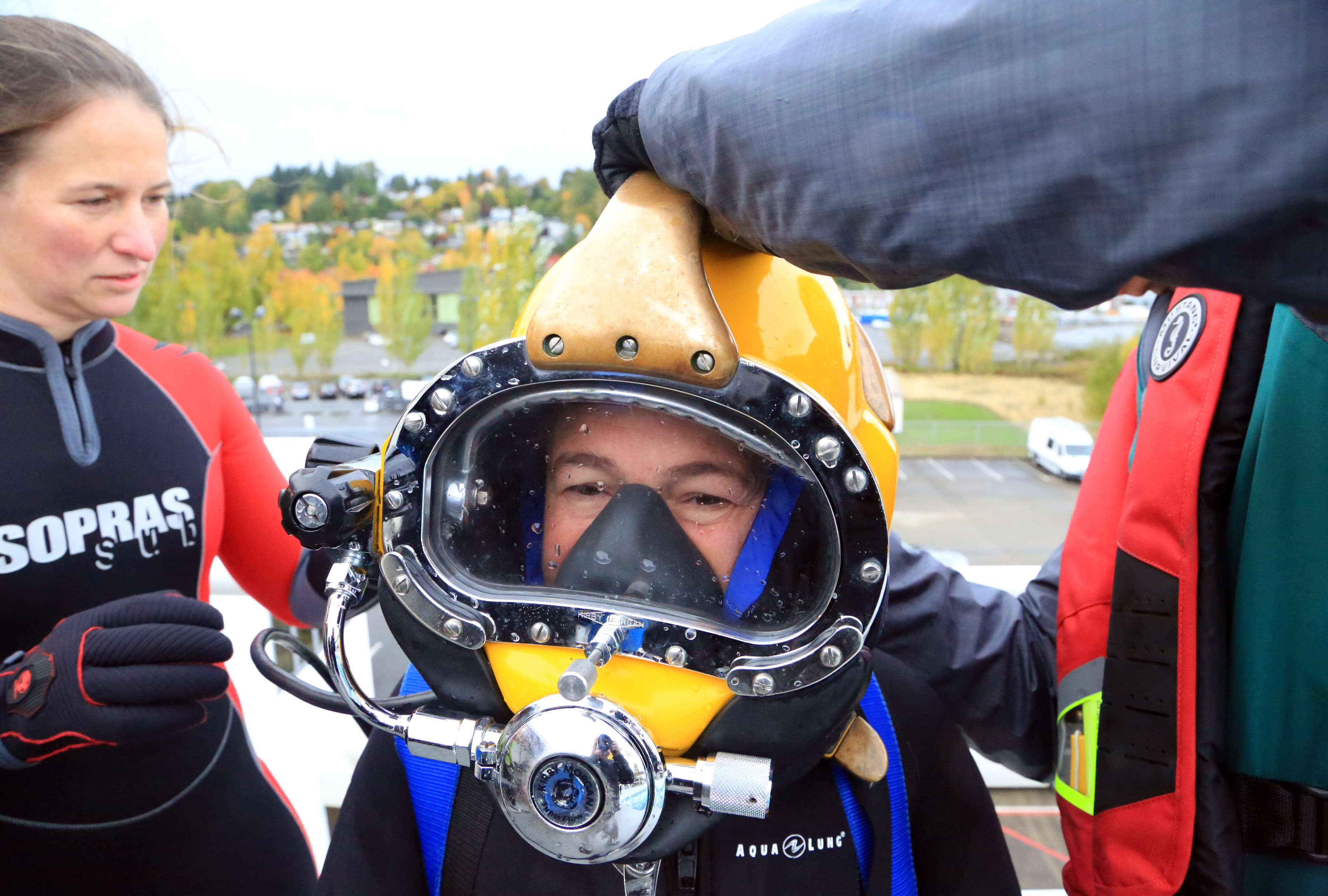 A diver with a surface supplied helmet on her head