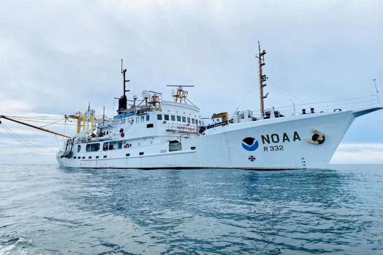 A white NOAA ship on the ocean