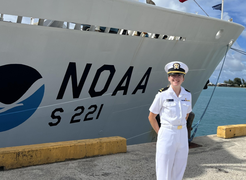 A NOAA Corps officer standing in front of NOAA Ship Rainier