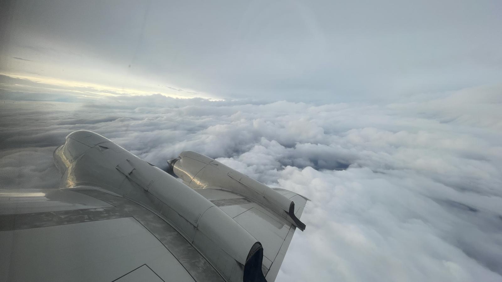 View showing right wing of NOAA aircraft and clouds from Tropical Storm Idalia