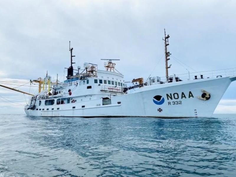 A white NOAA ship on the ocean