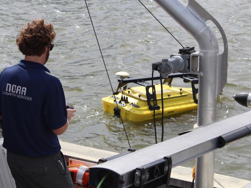 A yellow autonomous surface vehicle in the water