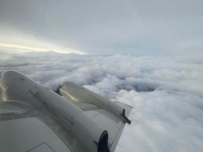View showing right wing of NOAA aircraft and clouds from Tropical Storm Idalia