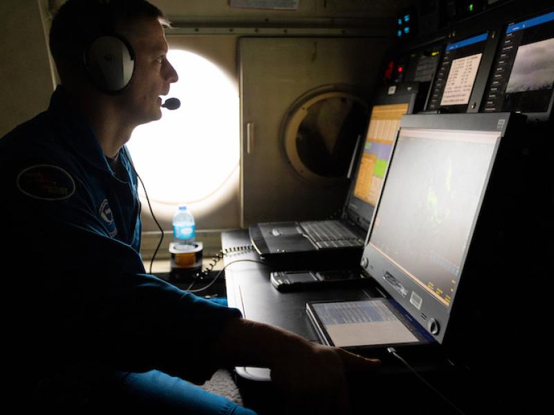Flight Director sits at workstation in aircraft