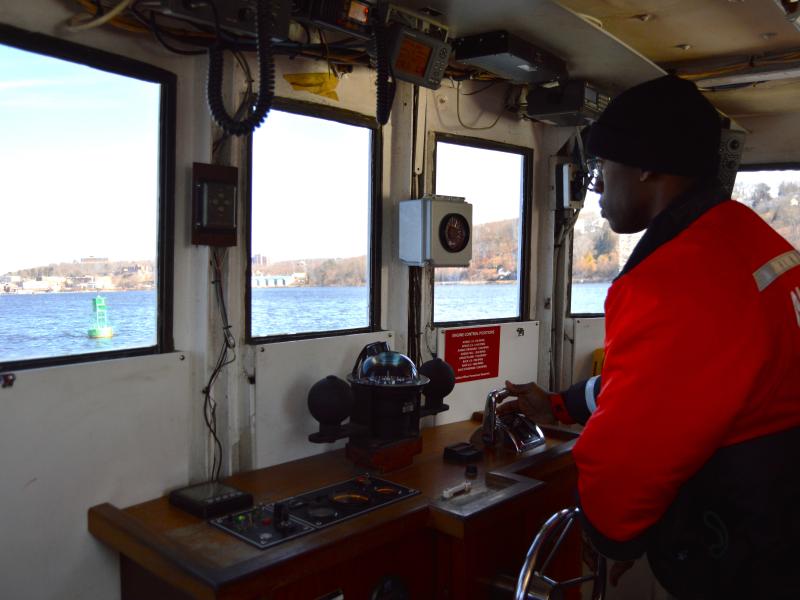 NOAA Corps officer candidate, Edward Harris, practicing station keeping on the Thames river on United States Coast Guard Academy training boat.