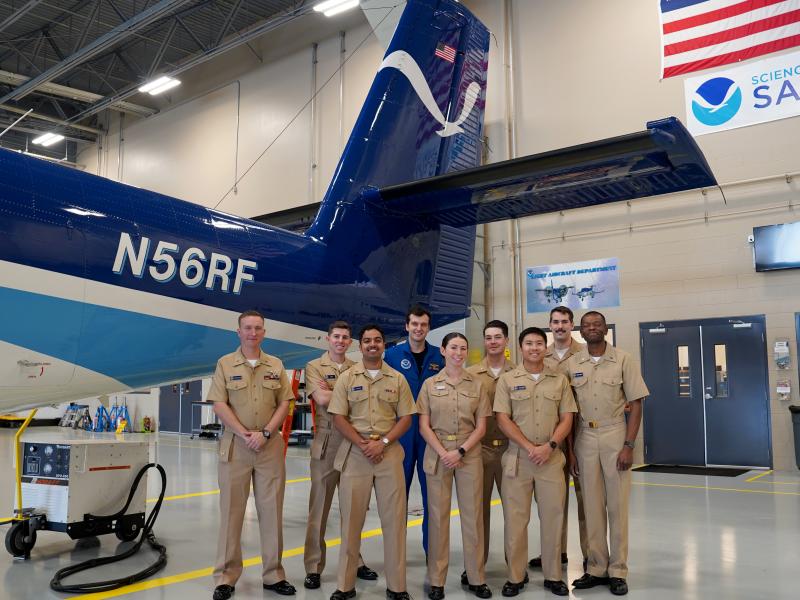 Newly commissioned NOAA Corps pilots stand in front of NOAA Twin Otter NOAA56 with Ensign Davis Benningfield and Lt. Eric Fritzsche during their tour of the NOAA Aircraft Operations Center in Lakeland, FL.(From L to R): ENS Dylan Legus-Sleigh, ENS Christian Eden, ENS Brian D'Souza, ENS Davis Benningfield, ENS Sara Towers, ENS James Seibert, ENS Wally Wibowo, Lt. Eric Fritzsche, ENS Ghislain Martial Ngangnang Ngangte