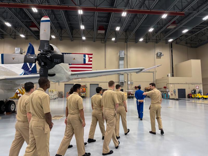 Lt. Eric Fritzsche leads new NOAA Commissioned Officer Corps pilots on a tour of the NOAA Aircraft Operations Center hangar.