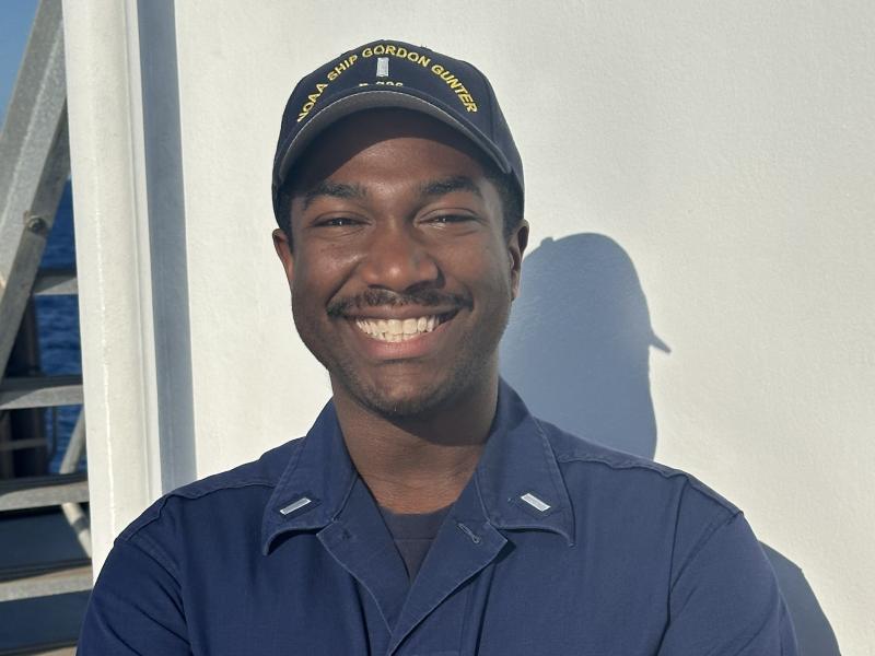 A male NOAA Corps officer on the deck of a NOAA ship