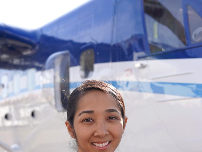NOAA Corps Officer poses in front of NOAA Twin Otter