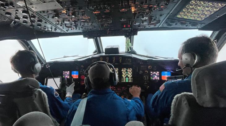 Pilots and flight engineer at the controls of NOAA WP-3D Orion N42RF during flight into Hurricane Ian