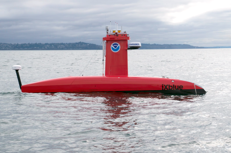 A bright orange uncrewed surface vessel floating on the water