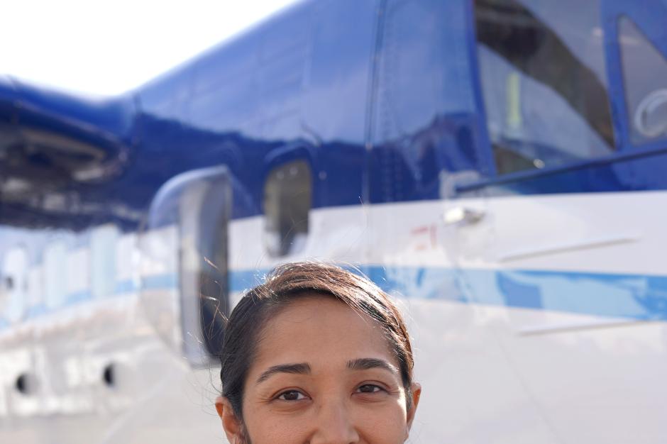 NOAA Corps Officer poses in front of NOAA Twin Otter