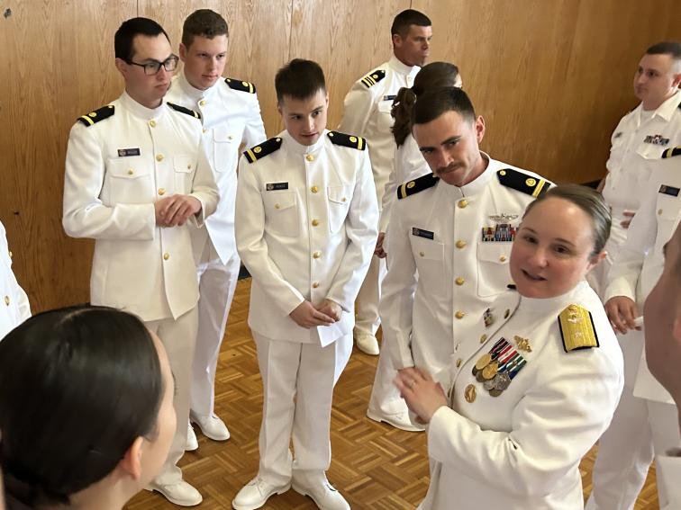 RDML Amanda Goeller (front right) talks to newly commissioned NOAA Corps officers. 